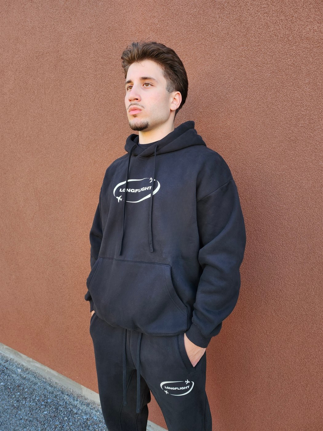 Model wearing the FlightMode Set in black, hoodie and matching sweatpants