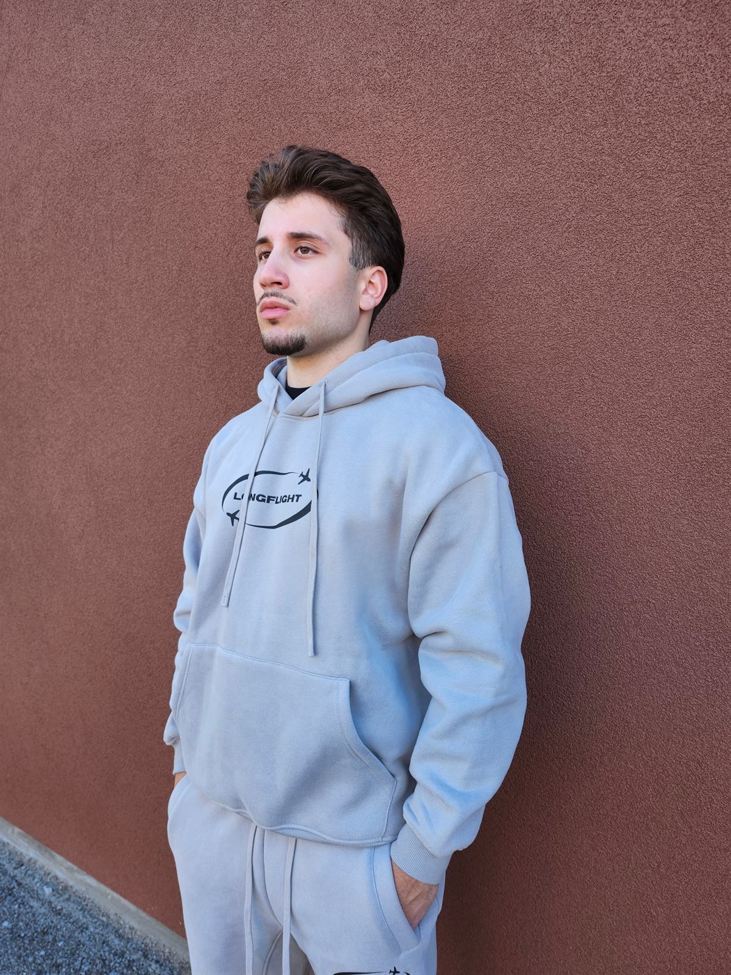 Model wearing the FlightMode Hoodie in grey, side