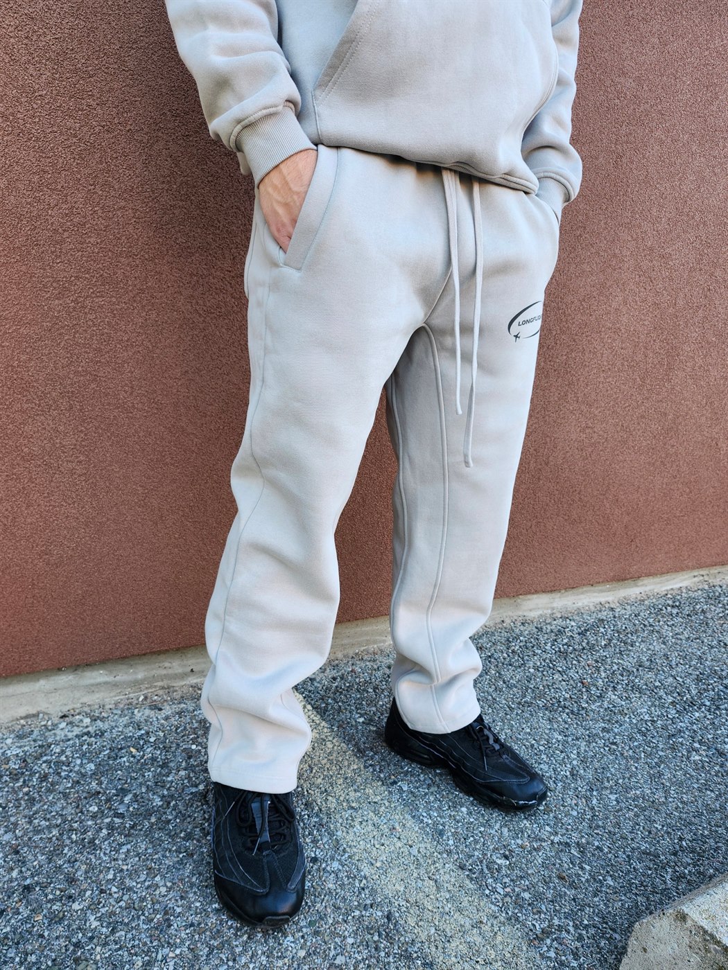 Model wearing the FlightMode Sweatpants in grey, full length